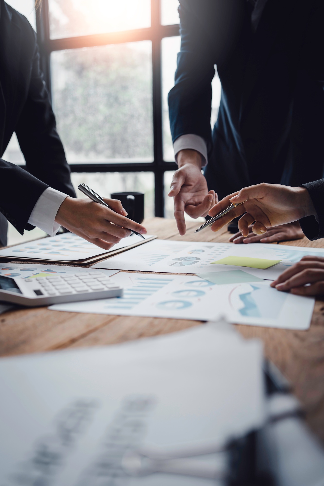 Businessmen meeting to plan, analyze, graph and chart business growth. to plan for new business