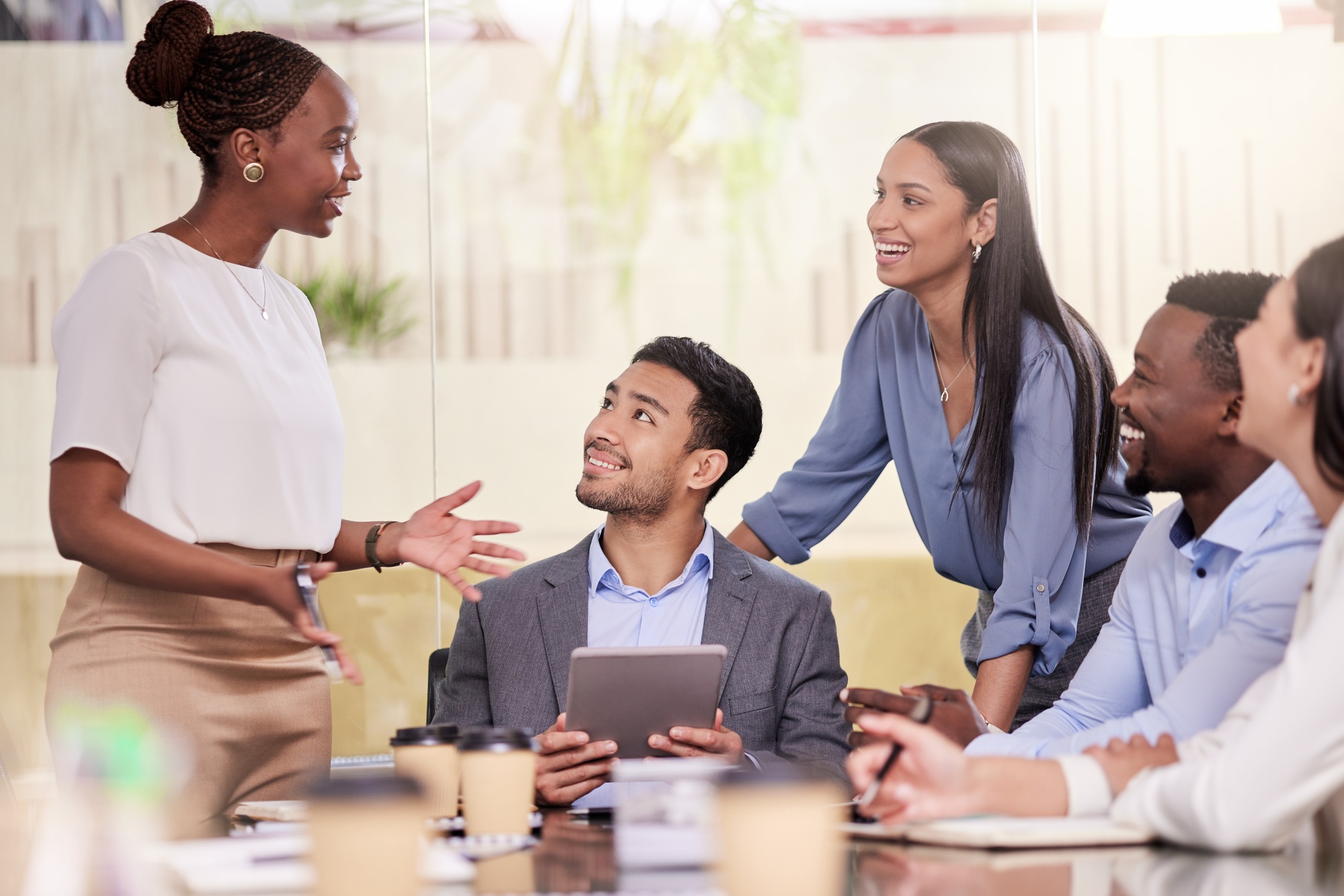 Shot of a group of coworkers using a digital tablet during a business meeting